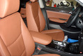 Перетяжка централького подлокотника и передних сидений  кожей в салоне BMW X3